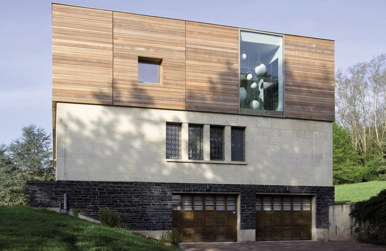 Photographie d'architecture d'une maison d'architecte avec une serre intérieure & extérieure.